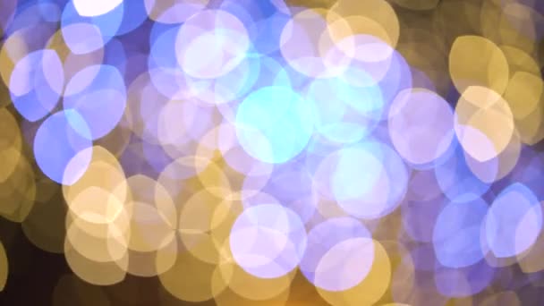Gyllene och blå bokeh cirklar av ljus på mörk bakgrund — Stockvideo