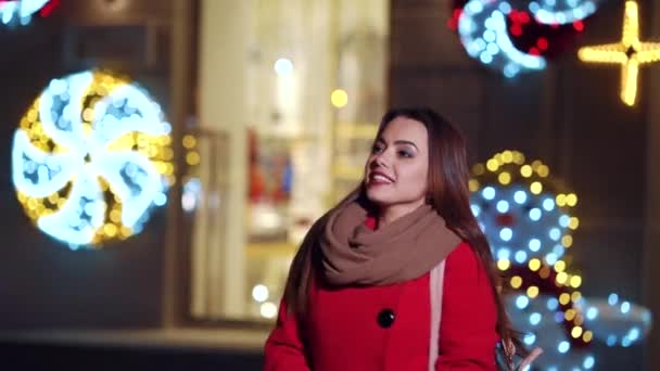 Радостная девушка ходит по улице в праздничный сезон — стоковое видео