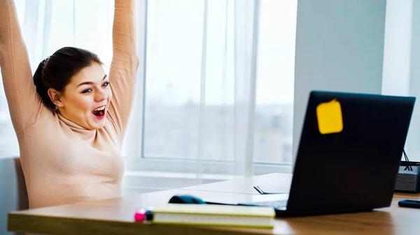 Successful office girl raising hands with joy