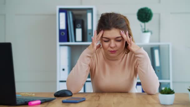 Young girl sitting in modern office and having headache — Stok video