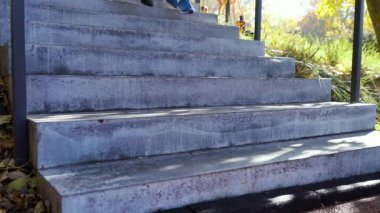Jogger feet running downstairs in autumn park