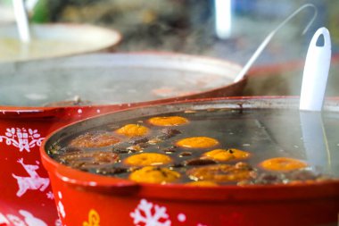 Spicy mulled wine in big red bowls on Christmas market