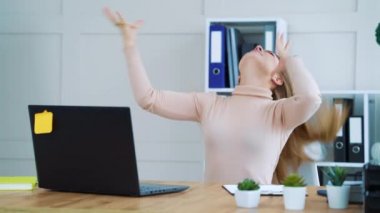 Bored girl in office making hair bun