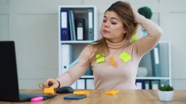 Tired office girl ungluing stickers from her clothes