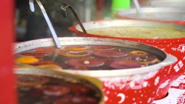 Hot mulled wine in big bowls on Christmas holiday market