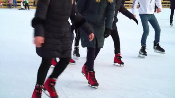 Families and friends enjoying skating on ice rink in winter — Stock Video