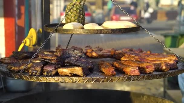 Big grill with pork ribs, bread and pineapple at street food festival — Stok video