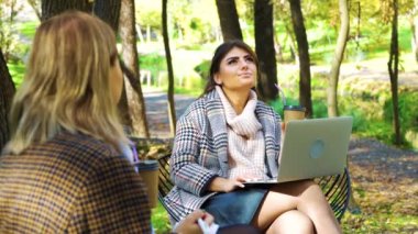 Business meeting of successful women in beautiful park