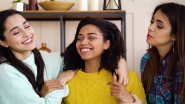 Multiracial female friends laughing and having fun together at home