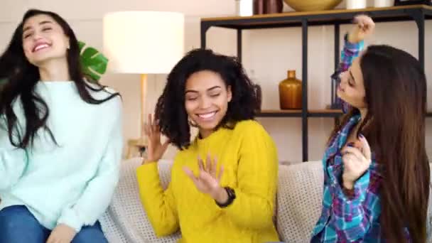 Happy female friends spending time together and dancing on sofa at home — Stok video