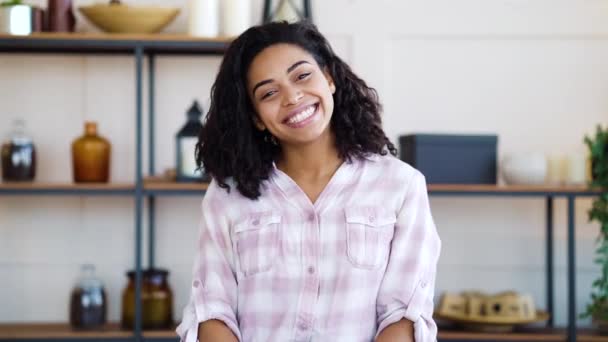 Happy black girl sitting at home and smiling at camera — 비디오