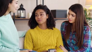 Young multiracial girls spending leisure in living room