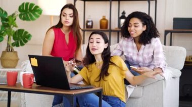 Pretty girl receiving good news and female roommates congratulating her