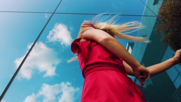 Low angle of attractive female dancer in red dress against mirror surface — Stock Video