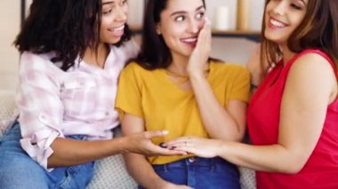 Female hand of happy bride with engagement ring showing it to friends at home