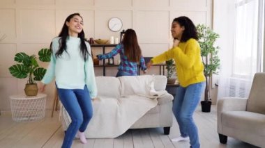 Diverse friends having party and dancing at home