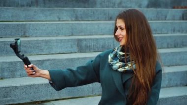 Young social media influencer streaming from public park