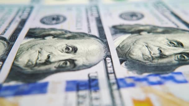 Macro dolly shot of American hundred dollar bills lying in row — Stock Video