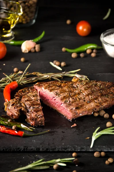 Rare steak black square plate spices slate — Stock Photo, Image