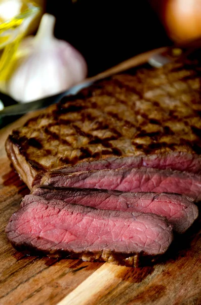 Sliced rare steak pepper salt garlic fork — Stock Photo, Image