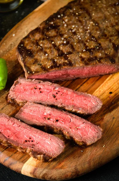 Chopped rare steak pepper salt garlic knife — Stock Photo, Image