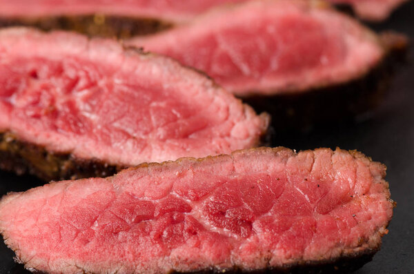 beef rare steak sliced plate close up