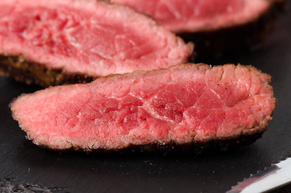 beef rare steak sliced close up