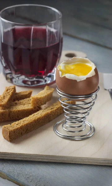 an egg in a mess with crackers and cherry juice