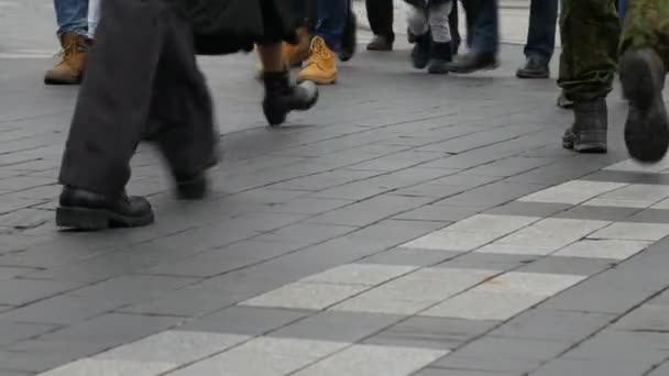 People step across a road by crosswalk or zebra crossing. — Stock Video