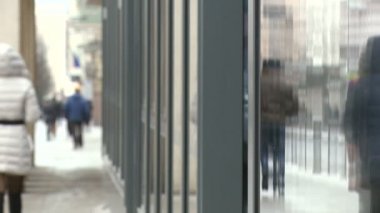 Anonim insanlar bir şehrin Vitrini yansımaları ile sokakta yürürken