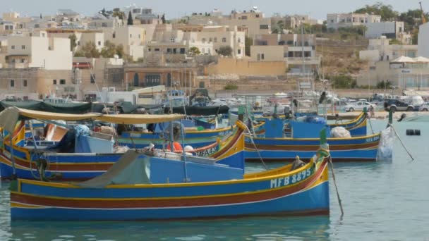 MARSAXLOKK, MALTA - 6 de julio de 2016: Hermosa arquitectura de pueblo pesquero con barcos de colores anclados en una bahía — Vídeo de stock