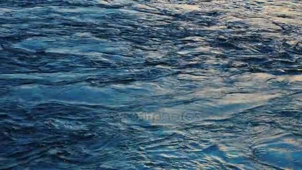 Dark blue water surface with moving ripple and air bubbles. — Stock Video