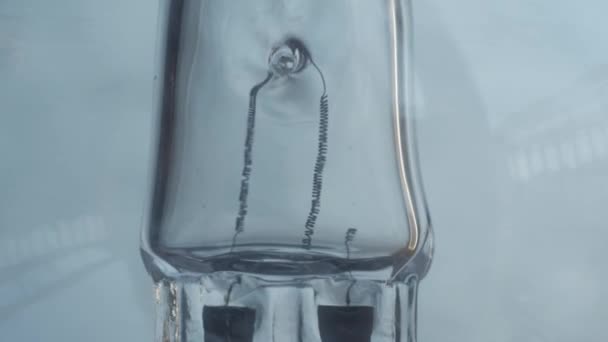 Close Up of light bulb over silver background. Electricity. — Stock Video