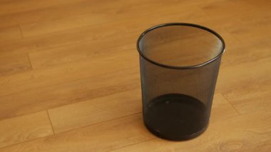 Ezilmiş kağıt çöp tenekesine savurma.