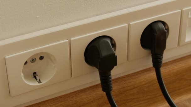 Close up of man hand putting plug in electricity socket. — Stock Video