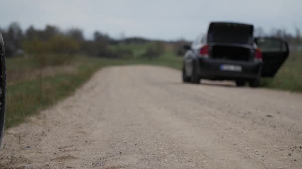 Used tire eliminated at roadside. Nature pollution. — Stock Video