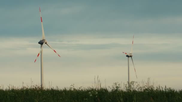 Wind turbines isolated on overcast sky background — Stock Video