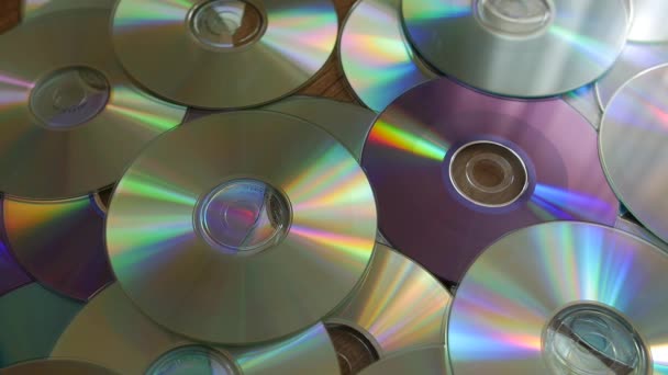 Optical Discs falling onto pile of DVDs or CDs. — Stock Video