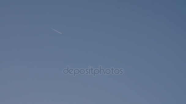 Avion jet vole dans le ciel bleu, laissant une traînée de vapeur .