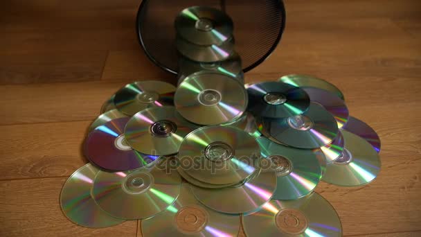 Several useless digital discs falling out of the dustbin. — Stock Video