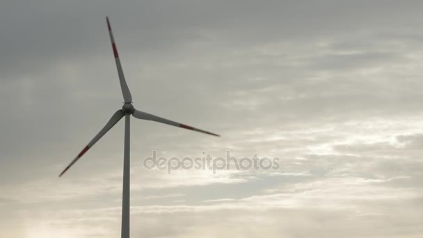 Wind turbine over stormy cloudy sky using renewable energy to generate electrical power. — Stock Video