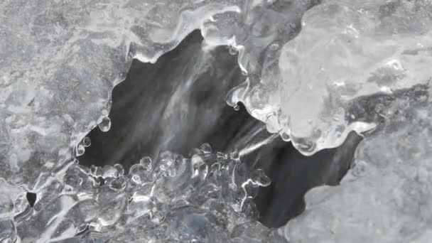 Frozen Mountain Stream. Under the ice build up running mountain stream close-up. — Stock Video