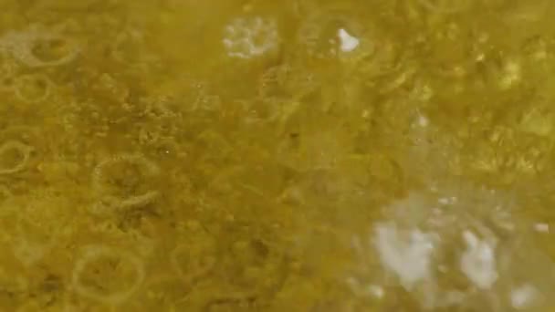 Abstract boiling solid yellow liquid, close up top view. — Stock Video