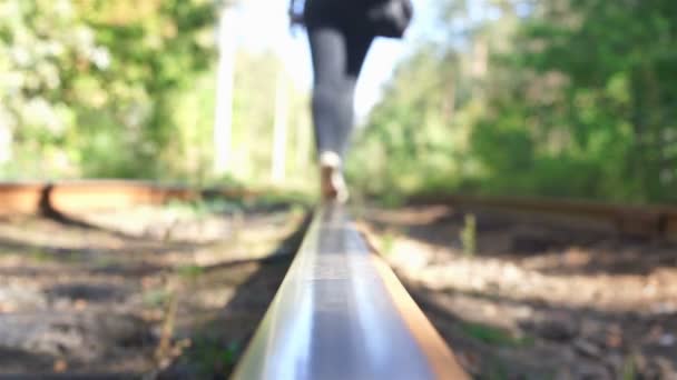 Woman with luggage walking down railroad track, leaving place. Wanderer, tourist — Αρχείο Βίντεο