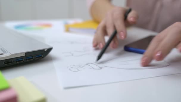 Female designer drawing dress sketches, sitting at table, business startup, job — 비디오