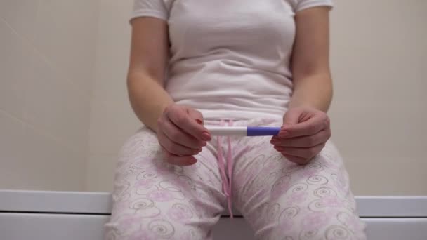 Young woman checking ovulation test in bathroom, preparing for healthy pregnancy — Stock Video
