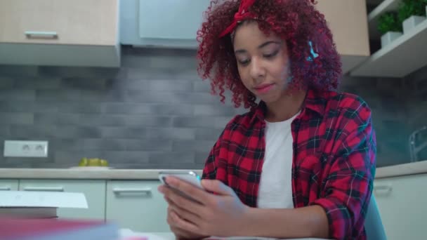 Modern teen girl browsing internet on smartphone, listening music in earphones — Stock Video