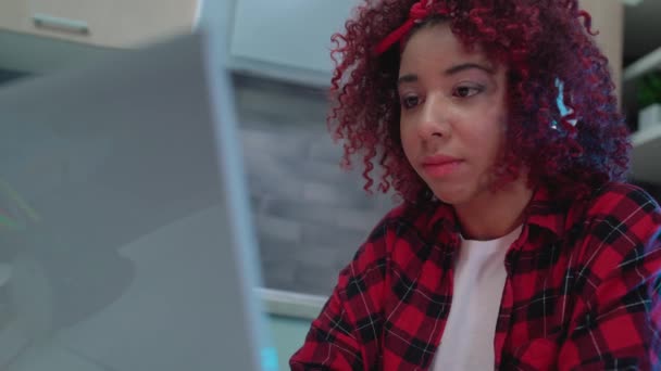 Menina afro-americana assistindo vídeo no computador portátil e sorrindo, se divertindo — Vídeo de Stock