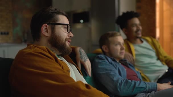 Group of friends watching football, discussing match, sitting on sofa, leisure — Stock Video