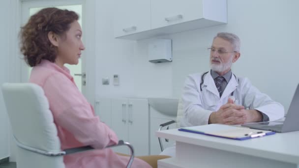 Gynécologue homme consultant patient à l'hôpital, services de santé féminine — Video